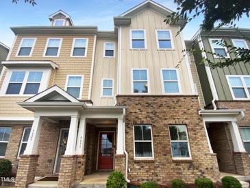 Brick townhouse with a red front door at 6631 Perry Creek Rd, Raleigh, NC 27616