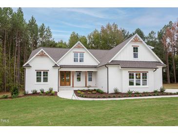 One story house with white brick exterior, brown roof, and double front doors at 10 Harvest View Way, Franklinton, NC 27525