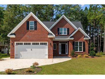 Brick house with two-car garage and landscaping at 440 Somerset Way, Rocky Mount, NC 27804