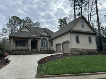 Two-story house with stone accents and a three-car garage at 22005 Turner, Chapel Hill, NC 27517