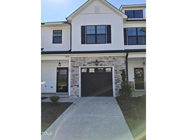 Two story home with stone and white accents at 727 Putney Hill Rd, Zebulon, NC 27597