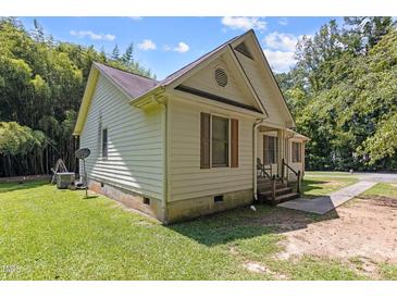 Ranch house with light beige siding, short porch, and walkway at 1515 Indian Camp Rd, Chapel Hill, NC 27516