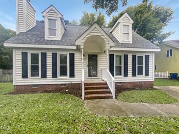 Charming two-story home with white siding and brick accents at 2809 Kempsford Pl, Raleigh, NC 27604