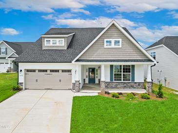 Two-story home with a gray exterior and teal door at 1055 Fairhaven Dr # 56, Mebane, NC 27302