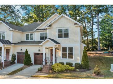 Two story tan home with attached garage, front steps, and landscaping at 532 Lena Cir, Chapel Hill, NC 27516