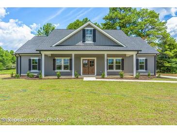 Gray farmhouse exterior with front porch and landscaping at Tbd 2 Cedar Lane Rd, Sanford, NC 27332