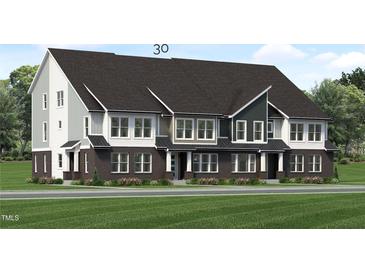 Modern three-story townhome with dark brick and light siding at 2413 Adrift Rd, Fuquay Varina, NC 27526