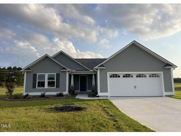 Newly built gray house with white garage doors at 53 Grace Ridge Ct, Benson, NC 27504