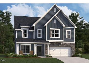 Two-story home with navy blue siding and stone accents at 3309 Oakfields Rd # 3, New Hill, NC 27562