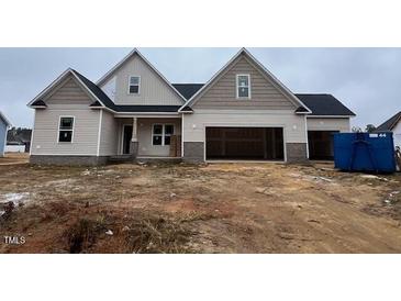 Two-story house with attached garage and neutral color scheme at 81 Seahawk Way, Zebulon, NC 27597