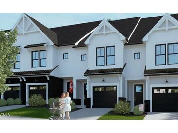Modern three-unit townhome building with attached garages at 4047 Elk Creek Ln # 13, Raleigh, NC 27612