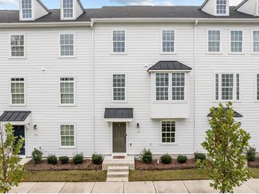 White three-story townhome with bay window at 104 Vallco Ln, Durham, NC 27713