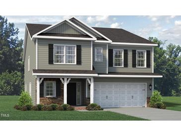 Two story house with gray siding, stone accents, and a three-car garage at 1938 Darrell Dr # 11, Graham, NC 27253