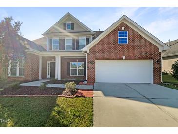 Brick home with two-car garage and landscaping at 9 Oxmoor Dr, Durham, NC 27703