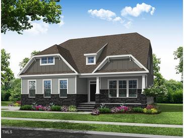 Stunning two-story home with gray siding, stone accents, and a welcoming front porch at 169 Sage Ln # 012, Four Oaks, NC 27524