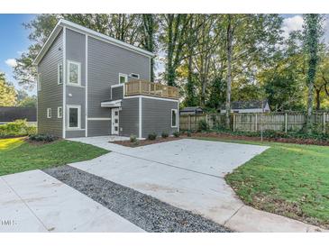 Two-story home with gray siding, a deck, and a concrete driveway at 112 N Guthrie Ave # A, Durham, NC 27703