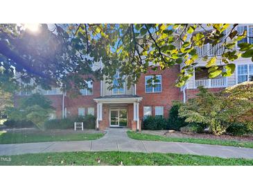 Brick building exterior with landscaping and walkway at 1414 Arborgate Cir, Chapel Hill, NC 27514