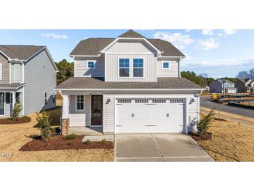 Two-story house with a gray roof, white siding, and a two-car garage at 20 Windflower Ct, Clayton, NC 27520