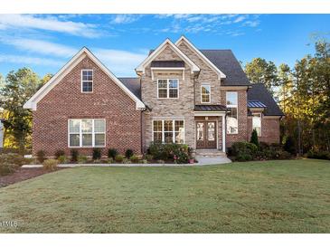 Brick house with stone accents and landscaping at 2028 Pleasant Forest Way, Wake Forest, NC 27587