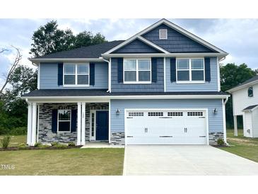 Two-story home with gray siding and white garage door at 333 Hopewell Branch Ct, Smithfield, NC 27577