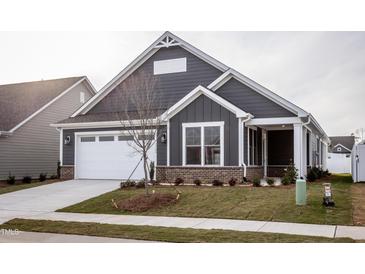 Gray house with white garage door and landscaping at 1724 Red Elm Lane, Homesite 76, Fuquay Varina, NC 27526
