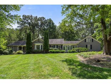 Gray, ranch style home with mature landscaping at 2445 Pineway Dr, Burlington, NC 27215