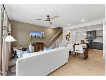 Open concept living room and kitchen with modern finishes at 602 Market Grove Dr # 100, Wake Forest, NC 27587