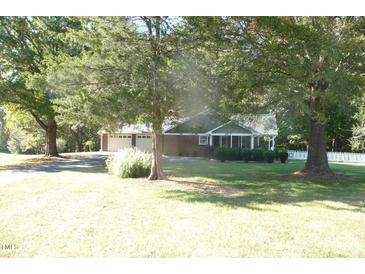 Brick ranch house with attached garage and fenced yard at 5906 Lillian Dr, Hurdle Mills, NC 27541