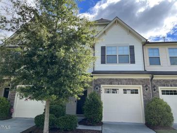 Two-story townhome with a two-car garage and landscaping at 140 Token House Rd, Durham, NC 27703
