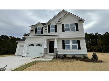 Two-story home with a two-car garage and landscaping at 726 Sherrill Farm Dr, Benson, NC 27504