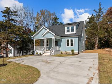 Charming light blue house with driveway and landscaping at 2015 Cheek Rd, Durham, NC 27704