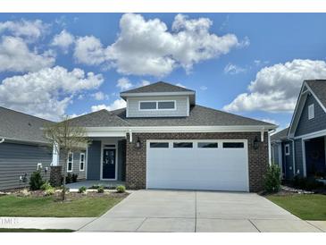 Brick home with a two-car garage and landscaping at 124 Swain St, Clayton, NC 27527