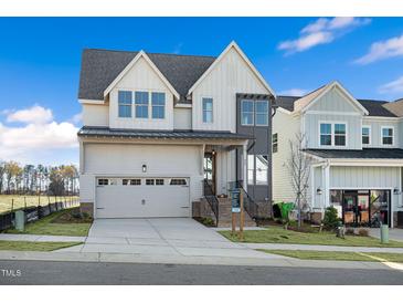 Two-story modern farmhouse style home with gray and white exterior at 465 Douglas Falls Dr, Wendell, NC 27591