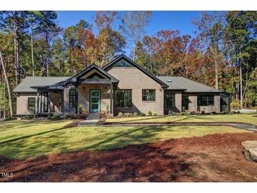 Stunning brick home with modern design and landscaping at 1414 Whippoorwill Ln, Chapel Hill, NC 27517