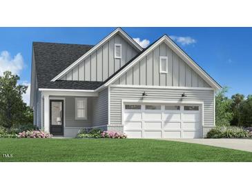 One-story house with gray siding, two-car garage, and landscaping at 520 Gainer Dr # 6, Raleigh, NC 27610