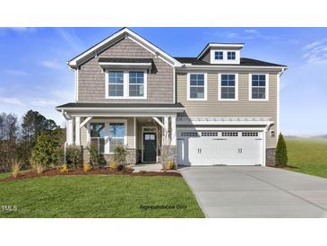 Two story home with stone accents and landscaping at 71 Macy Cir, Wendell, NC 27591