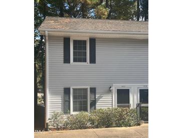 Gray vinyl sided duplex with shutters and landscaping at 1111 Nottingham Cir, Cary, NC 27511