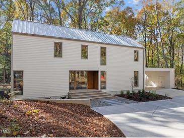 Modern two-story home with metal roof and wooded setting at 770 New Grady Brown School Rd, Hillsborough, NC 27278