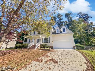 Two-story house with a large front yard and driveway at 411 Brook Creek Dr, Cary, NC 27519