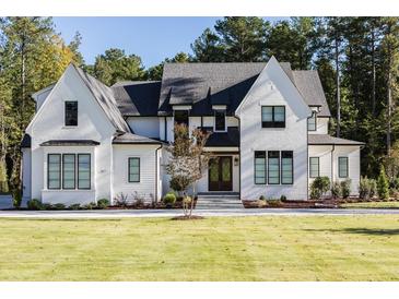 Two-story white brick home with black windows and a large front yard at 017 Bartley Holleman Rd # 17, New Hill, NC 27562