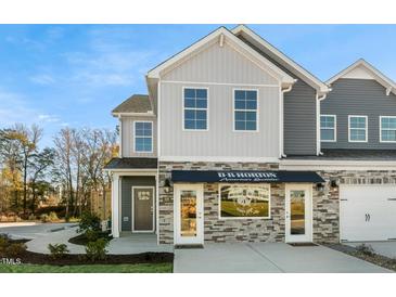 Modern two-story townhome with stone and gray siding at 734 Apple Churn Dr, Fuquay Varina, NC 27526