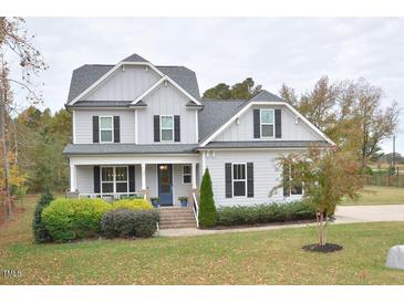 Two-story home with gray siding, brick accents, and a welcoming front porch at 30 Willow Bend Dr, Youngsville, NC 27596
