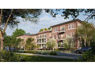 Brick building exterior with balconies and landscaping at 2606 Marchmont St # 102, Raleigh, NC 27608