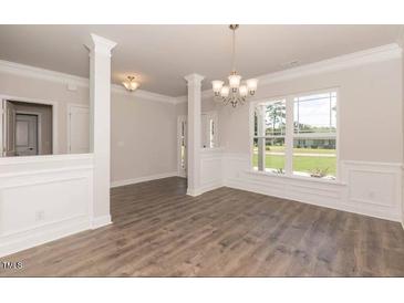 Bright dining room with hardwood floors and columns at 110 Lemon Drop Ln, Franklinton, NC 27525