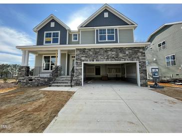 Two-story house with stone accents and a two-car garage at 1505 Maelyn Way, Fuquay Varina, NC 27526