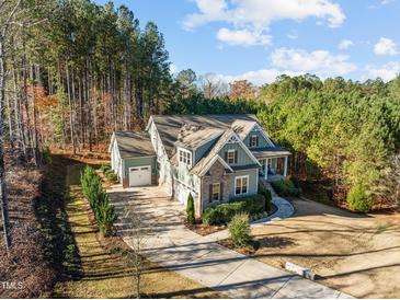 Two-story house with a large backyard, driveway, and attached garage at 181 Colonial Ridge Dr, Pittsboro, NC 27312
