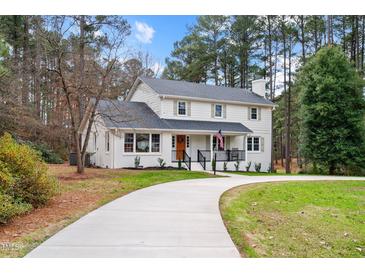 Two-story house with white brick, gray roof, and a long driveway at 85 Cotten Rd, Sanford, NC 27330