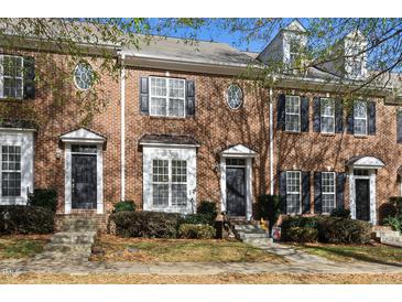 Brick townhouses with black shutters, and front yards at 130 W Savannah Ridge Rd, Holly Springs, NC 27540