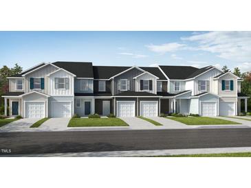 Exterior view of three townhouses with garages at 120 Parker Ln, Mebane, NC 27302