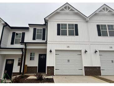 Charming two-story home with white siding, black shutters, and attached garage at 132 S Mistflower St, Clayton, NC 27520